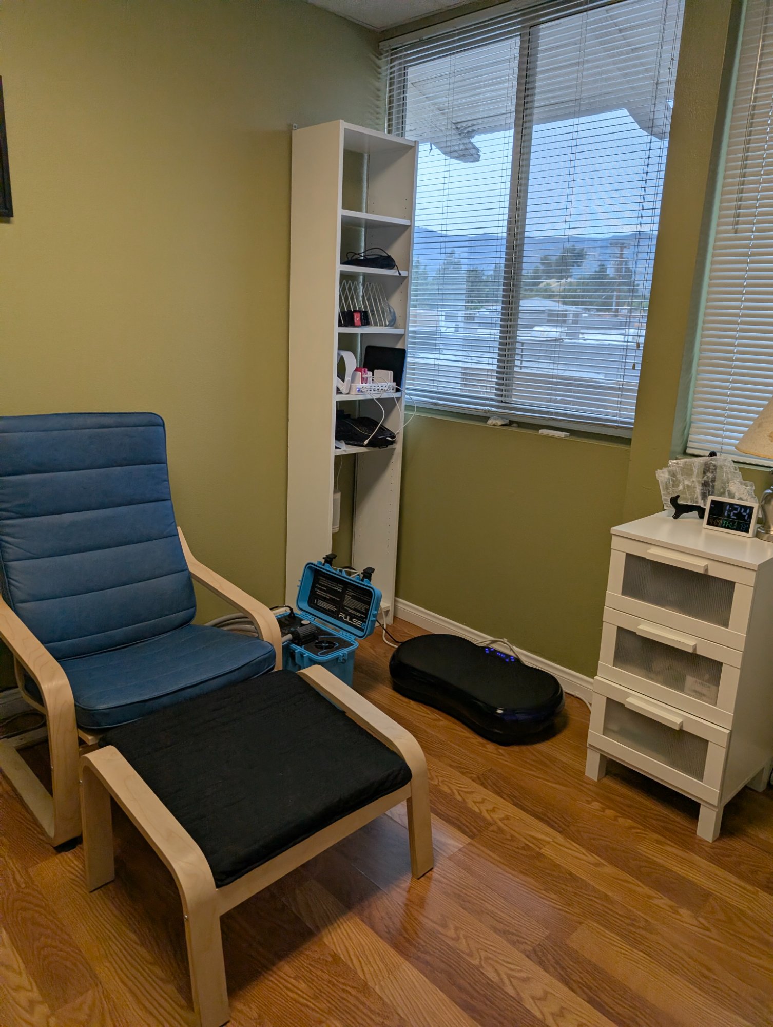 The Recharge Lab recovery room — PEMF chair, vibration plate, and window view